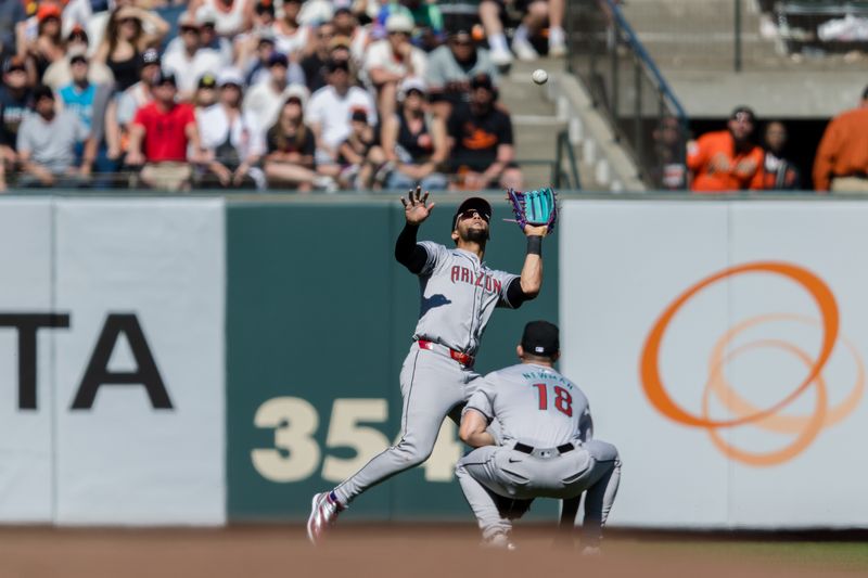 Apr 21, 2024; San Francisco, California, USA;  Arizona Diamondbacks left fielder Lourdes Gurriel Jr. (12) catches a deep fly ball against the San Francisco Giants during the ninth inning at Oracle Park. Mandatory Credit: John Hefti-USA TODAY Sports