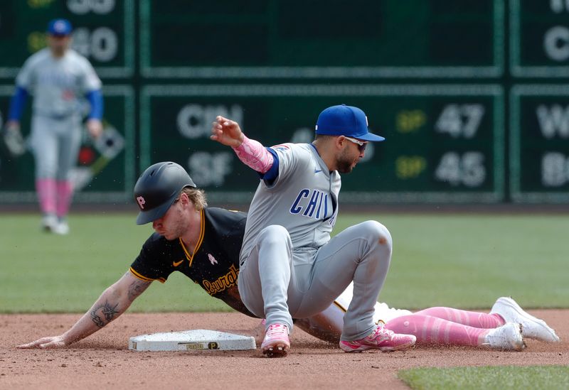 May 12, 2024; Pittsburgh, Pennsylvania, USA;  Pittsburgh Pirates center fielder Jack Suwinski (rear) steals second base as Chicago Cubs second baseman Nick Madrigal (1) applies a late tag during the fourth inning at PNC Park. Mandatory Credit: Charles LeClaire-USA TODAY Sports