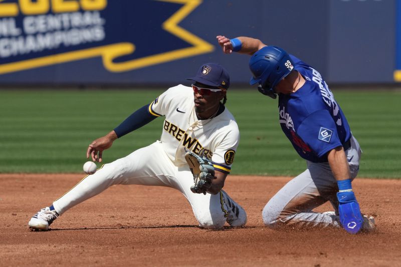 Mar 9, 2026; Phoenix, Arizona, USA; Los Angeles Dodgers outfielder Zach Ehrhard (99) steals second base under the tag by Milwaukee Brewers second baseman Greg Jones (70) in the second inning at American Family Fields of Phoenix. Mandatory Credit: Rick Scuteri-Imagn Images