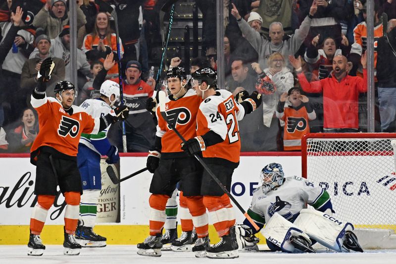 Dec 22, 2025; Philadelphia, Pennsylvania, USA; Philadelphia Flyers center Christian Dvorak (22) celebrates his goal against Vancouver Canucks goaltender Thatcher Demko (35) during the third period at Xfinity Mobile Arena. Mandatory Credit: Eric Hartline-Imagn Images