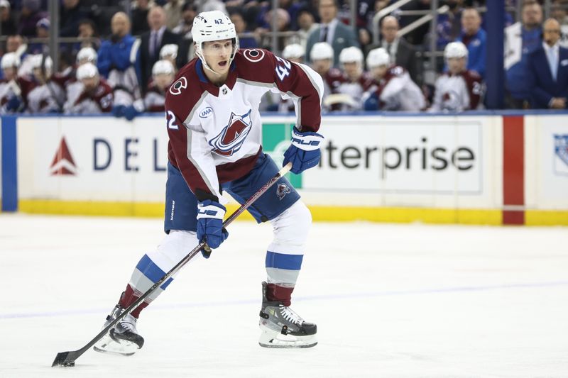 Jan 26, 2025; New York, New York, USA;  Colorado Avalanche defenseman Josh Manson (42) controls the puck in the first period against the New York Rangers at Madison Square Garden. Mandatory Credit: Wendell Cruz-Imagn Images
