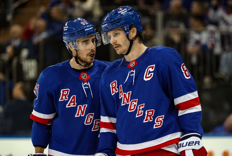 Nov 25, 2024; New York, New York, USA; New York Rangers right wing Reilly Smith (91) talks with defenseman Jacob Trouba (8) during a timeout against the St. Louis Blues during the first period at Madison Square Garden. Mandatory Credit: Danny Wild-Imagn Images