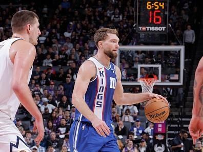 SACRAMENTO, CA - DECEMBER 2: Domantas Sabonis #10 of the Sacramento Kings handles the ball against defender Nikola Jokic #15 of the Denver Nuggets during the game on December 2, 2023 at Golden 1 Center in Sacramento, California. NOTE TO USER: User expressly acknowledges and agrees that, by downloading and or using this Photograph, user is consenting to the terms and conditions of the Getty Images License Agreement. Mandatory Copyright Notice: Copyright 2023 NBAE (Photo by Rocky Widner/NBAE via Getty Images)