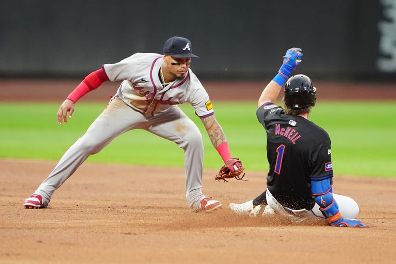 Jul 25, 2024; New York City, New York, USA; Atlanta Braves shortstop Orlando Arcia (11) tags out New York Mets left fielder Jeff McNeil (1) attempting to stretch a single into a double during the second inning at Citi Field. Mandatory Credit: Gregory Fisher-USA TODAY Sports