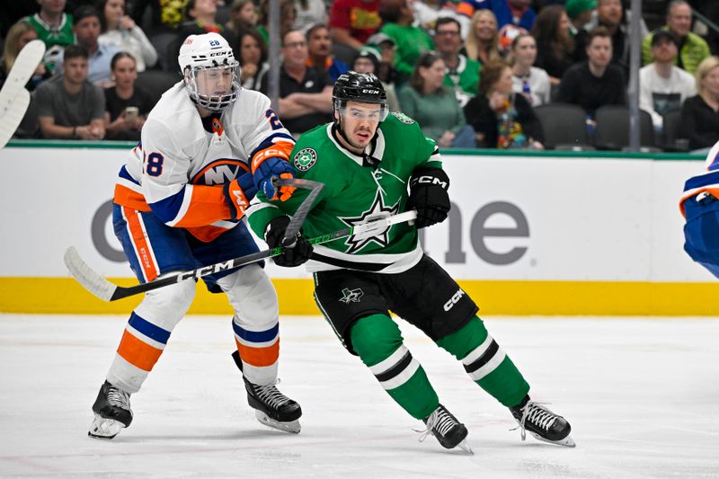 Feb 26, 2024; Dallas, Texas, USA; New York Islanders defenseman Alexander Romanov (28) checks Dallas Stars center Logan Stankoven (11) during the second period at the American Airlines Center. Mandatory Credit: Jerome Miron-USA TODAY Sports