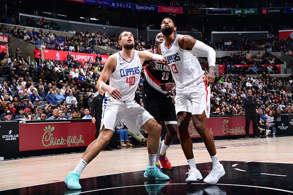 LOS ANGELES, CA - DECEMBER 11: Ivica Zubac #40 and Paul George #13 of the LA Clippers box out of the rebound during the game against the Portland Trail Blazers on December 11, 2023 at Crypto.Com Arena in Los Angeles, California. NOTE TO USER: User expressly acknowledges and agrees that, by downloading and/or using this Photograph, user is consenting to the terms and conditions of the Getty Images License Agreement. Mandatory Copyright Notice: Copyright 2023 NBAE (Photo by Adam Pantozzi/NBAE via Getty Images)