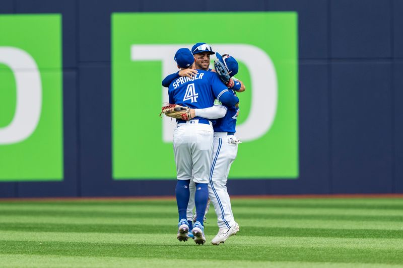 Aug 13, 2023; Toronto, Ontario, CAN; Toronto Blue Jays second baseman Whit Merrifield (15) celebrates with teammates right fielder George Springer (4), and left fielder Daulton Varsho (25) after defeating the Chicago Cubs at Rogers Centre. Mandatory Credit: Kevin Sousa-USA TODAY Sports