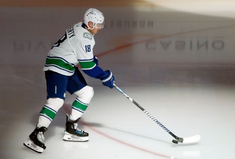 Jan 11, 2024; Pittsburgh, Pennsylvania, USA; Vancouver Canucks center Sam Lafferty (18) takes the ice to warm up before the game against the Pittsburgh Penguins at PPG Paints Arena. Mandatory Credit: Charles LeClaire-USA TODAY Sports