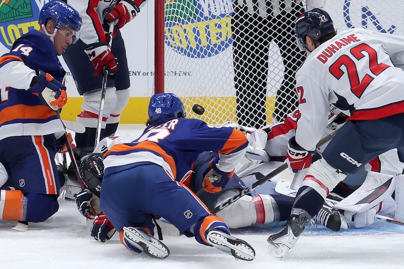 Oct 11, 2025; Elmont, New York, USA; New York Islanders defenseman Matthew Schaefer (48) scores a goal against the Washington Capitals during the third period at UBS Arena. The goal was the first of his NHL career. Mandatory Credit: Brad Penner-Imagn Images