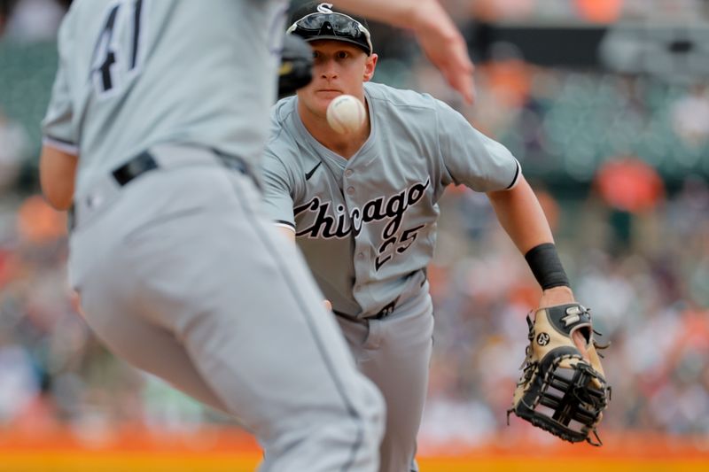 Jun 23, 2024; Detroit, Michigan, USA;  Chicago White Sox first baseman Andrew Vaughn (25) underhands the ball to relief pitcher Chad Kuhl (41) to make a play in the fourth inning against the Detroit Tigers at Comerica Park. Mandatory Credit: Rick Osentoski-USA TODAY Sports