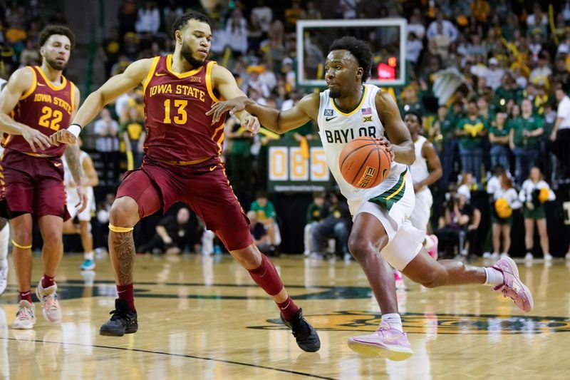 Mar 4, 2023; Waco, Texas, USA; Baylor Bears guard LJ Cryer (4) drives on Iowa State Cyclones guard Jaren Holmes (13) during the second half at Ferrell Center. Mandatory Credit: Raymond Carlin III-USA TODAY Sports