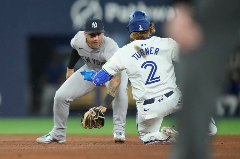 Apr 16, 2024; Toronto, Ontario, CAN; New York Yankees second baseman Gleyber Torres (25) catches Toronto Blue Jays designated hitter Justin Turner (2) stealing second base during the fifth inning at Rogers Centre. Mandatory Credit: John E. Sokolowski-USA TODAY Sports