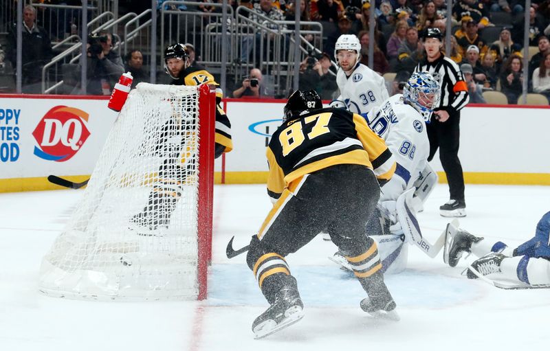 Apr 6, 2024; Pittsburgh, Pennsylvania, USA;  Pittsburgh Penguins center Sidney Crosby (87) scores a goal against Tampa Bay Lightning goaltender Andrei Vasilevskiy (88) during the first period at PPG Paints Arena. Mandatory Credit: Charles LeClaire-USA TODAY Sports