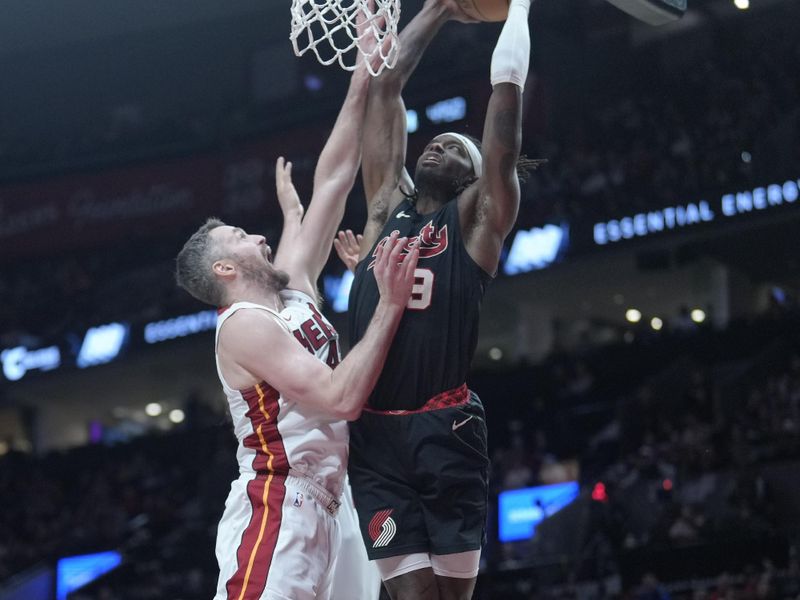 PORTLAND, OREGON - FEBRUARY 27: Jerami Grant #9 of the Portland Trail Blazers dunks the ball over Kevin Love #42 (L) of the Miami Heat during the first half at Moda Center on February 27, 2024 in Portland, Oregon. NOTE TO USER: User expressly acknowledges and agrees that, by downloading and or using this photograph, User is consenting to the terms and conditions of the Getty Images License Agreement. (Photo by Soobum Im/Getty Images)