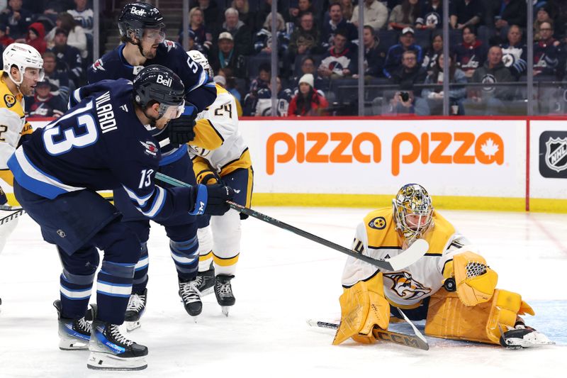 Jan 7, 2025; Winnipeg, Manitoba, CAN; Nashville Predators goaltender Juuse Saros (74) makes a glove save on a shot by Winnipeg Jets center Gabriel Vilardi (13) in the second period at Canada Life Centre. Mandatory Credit: James Carey Lauder-Imagn Images