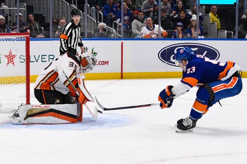 Dec 13, 2023; Elmont, New York, USA; Anaheim Ducks goaltender John Gibson (36) makes a save on New York Islanders center Casey Cizikas (53) during the second period at UBS Arena. Mandatory Credit: Dennis Schneidler-USA TODAY Sports