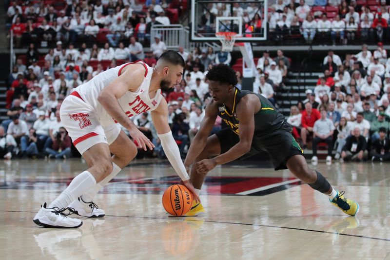 Jan 17, 2023; Lubbock, Texas, USA;  Texas Tech Red Raiders forward Fardaws Aimaq (11) and Baylor Bears guard Adam Flagler (10) go after a loose ball in the second half at United Supermarkets Arena. Mandatory Credit: Michael C. Johnson-USA TODAY Sports