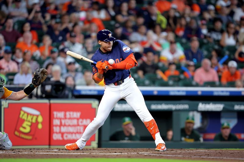 Jul 27, 2025; Houston, Texas, USA; Houston Astros right fielder Cam Smith (11) is hit by a pitch thrown by Athletics starting pitcher J.T. Ginn (70, not shown) during the second inning at Daikin Park. Mandatory Credit: Erik Williams-Imagn Images