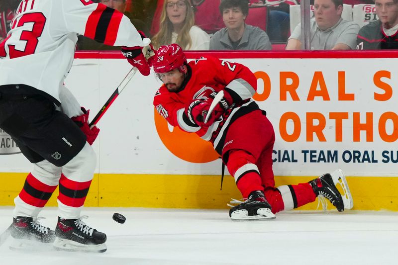 May 11, 2023; Raleigh, North Carolina, USA; Carolina Hurricanes center Seth Jarvis (24) passes against the New Jersey Devils in game five of the second round of the 2023 Stanley Cup Playoffs at PNC Arena. Mandatory Credit: James Guillory-USA TODAY Sports