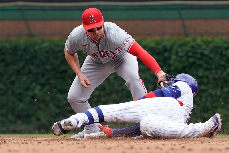 Jul 7, 2024; Chicago, Illinois, USA; Los Angeles Angels second base Brandon Drury (23) tags out Chicago Cubs catcher Miguel Amaya (9) out at second baseman during the third inning at Wrigley Field. Mandatory Credit: David Banks-USA TODAY Sports