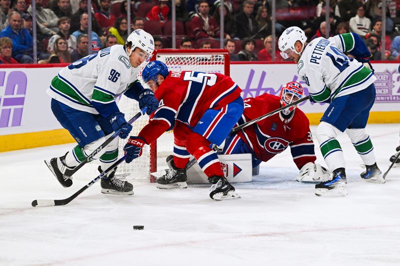 Nov 12, 2023; Montreal, Quebec, CAN; Vancouver Canucks left wing Andrei Kuzmenko (96) tracks the puck after Montreal Canadiens goalie Jake Allen (34) gives a rebound during the third period at Bell Centre. Mandatory Credit: David Kirouac-USA TODAY Sports