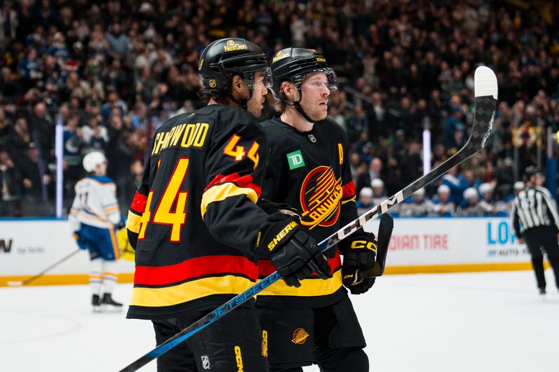 Dec 11, 2025; Vancouver, British Columbia, CAN; Vancouver Canucks forward Kiefer Sherwood (44) and forward Brock Boeser (6) celebrate Sherwood’s goal against the Buffalo Sabres in the first period at Rogers Arena. Mandatory Credit: Bob Frid-Imagn Images