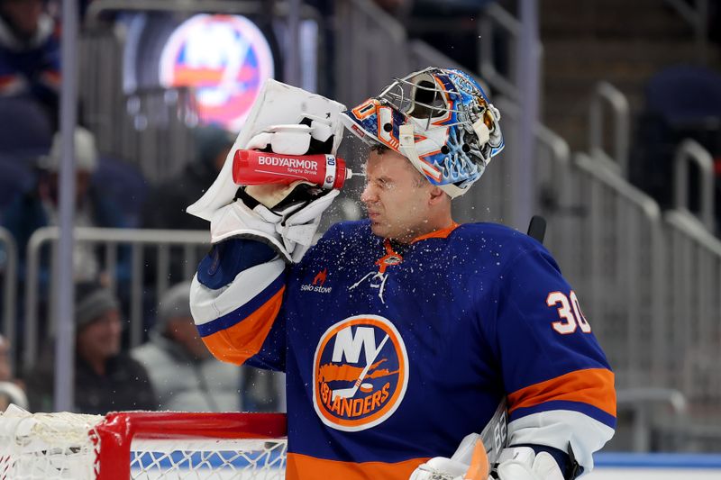 Nov 30, 2024; Elmont, New York, USA; New York Islanders goaltender Ilya Sorokin (30) sprays water on his face during the first period against the Buffalo Sabres at UBS Arena. Mandatory Credit: Brad Penner-Imagn Images