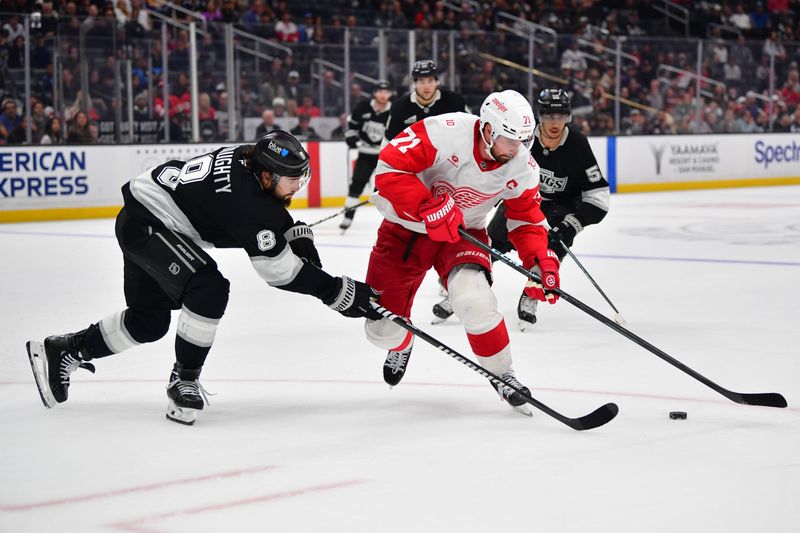 Oct 30, 2025; Los Angeles, California, USA; Los Angeles Kings defenseman Drew Doughty (8) plays for the puck against Detroit Red Wings center Dylan Larkin (71) during the third period at Crypto.com Arena. Mandatory Credit: Gary A. Vasquez-Imagn Images