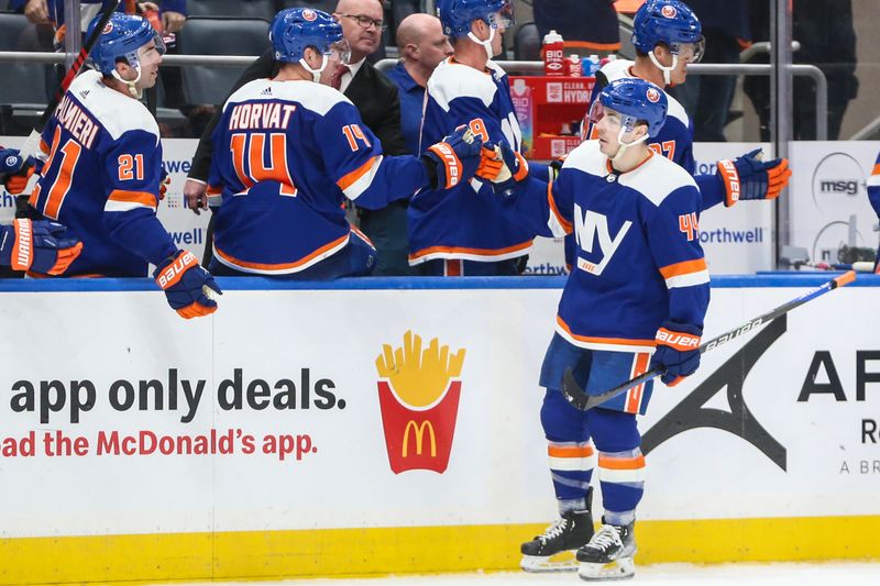 Feb 10, 2024; Elmont, New York, USA;  New York Islanders center Jean-Gabriel Pageau (44) celebrates with his teammates after scoring a goal in the third period against the Calgary Flames at UBS Arena. Mandatory Credit: Wendell Cruz-USA TODAY Sports