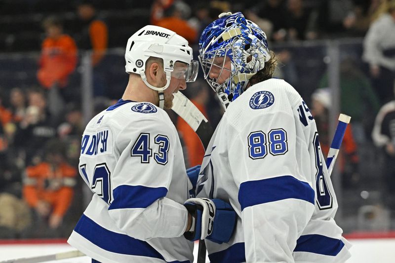 Jan 23, 2024; Philadelphia, Pennsylvania, USA; Tampa Bay Lightning defenseman Darren Raddysh (43) and goaltender Andrei Vasilevskiy (88) celebrate win against the Philadelphia Flyers during the third period at Wells Fargo Center. Mandatory Credit: Eric Hartline-USA TODAY Sports