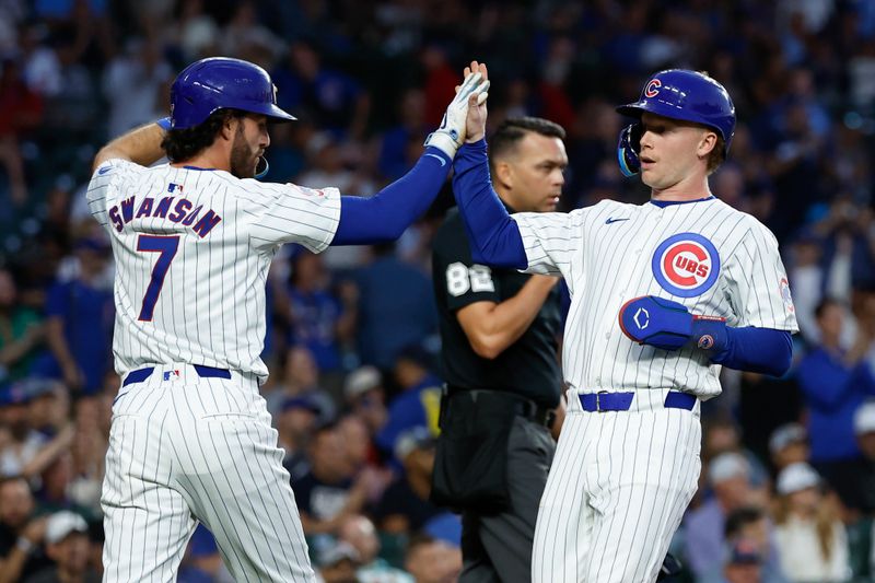 Sep 4, 2024; Chicago, Illinois, USA; Chicago Cubs shortstop Dansby Swanson (7) and outfielder Pete Crow-Armstrong (52) celebrate after scoring against the Pittsburgh Pirates during the second inning at Wrigley Field. Mandatory Credit: Kamil Krzaczynski-Imagn Images