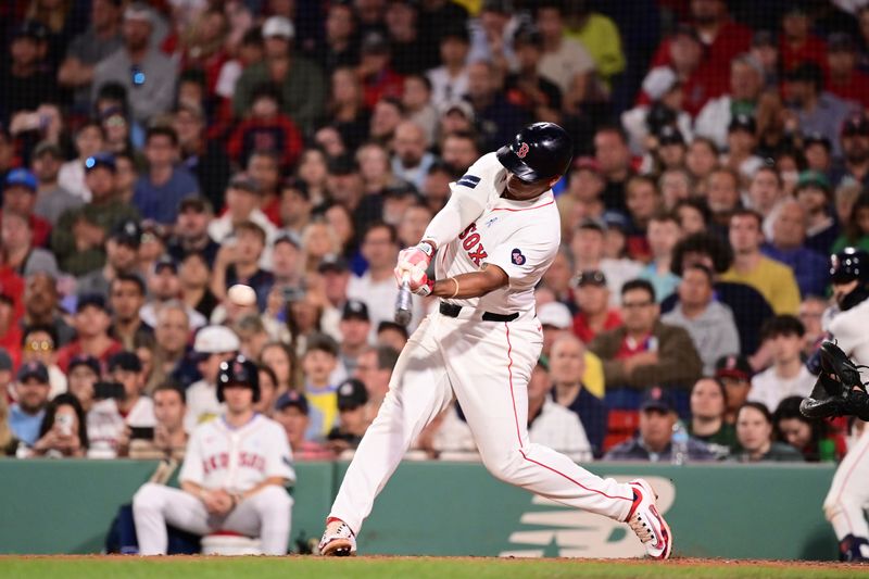 Jun 16, 2024; Boston, Massachusetts, USA; Boston Red Sox third baseman Rafael Devers (11) hits a single against the New York Yankees during the seventh inning at Fenway Park. Mandatory Credit: Eric Canha-USA TODAY Sports