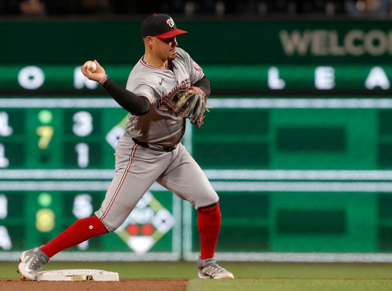 Sep 5, 2024; Pittsburgh, Pennsylvania, USA;  Washington Nationals second baseman Ildemaro Vargas (14) throws to first base to complete a double play against the Pittsburgh Pirates during the seventh inning at PNC Park. Mandatory Credit: Charles LeClaire-Imagn Images