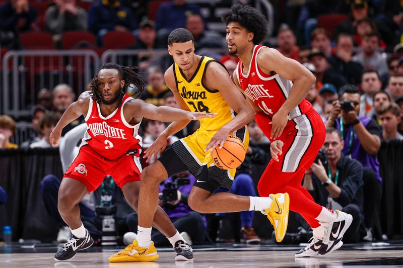 Mar 9, 2023; Chicago, IL, USA; Iowa Hawkeyes forward Kris Murray (24) is defended by Ohio State Buckeyes guard Sean McNeil (4) and forward Justice Sueing (14) during the first half at United Center. Mandatory Credit: Kamil Krzaczynski-USA TODAY Sports