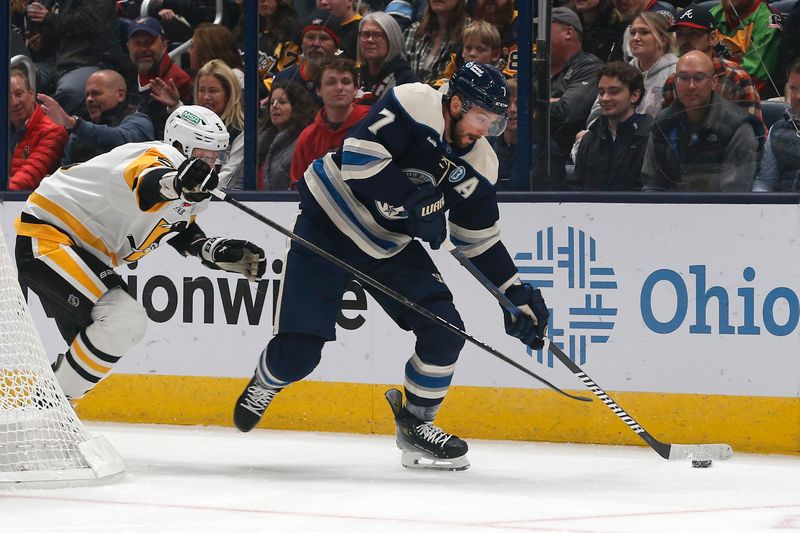 Nov 15, 2024; Columbus, Ohio, USA; Columbus Blue Jackets center Sean Kuraly (7) carries the puck as Pittsburgh Penguins defenseman Ryan Shea (5) trails the play during the first period at Nationwide Arena. Mandatory Credit: Russell LaBounty-Imagn Images