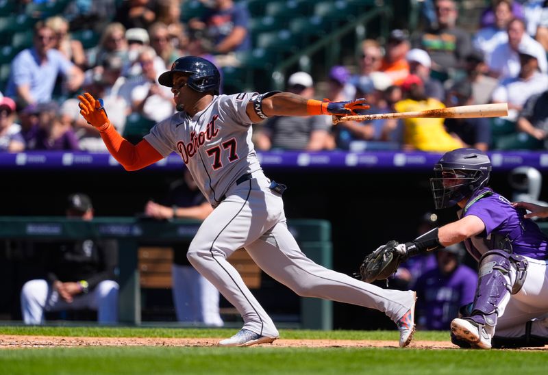 May 8, 2025; Denver, Colorado, USA; Detroit Tigers first baseman Andy Ibanez (77) singles in the seventh inning against the Colorado Rockies at Coors Field. Mandatory Credit: Ron Chenoy-Imagn Images