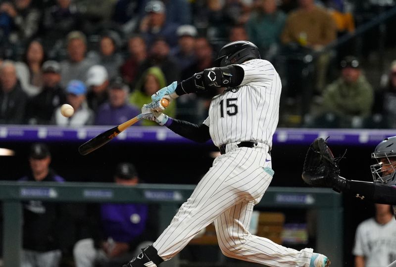 Sep 16, 2025; Denver, Colorado, USA; Colorado Rockies catcher Hunter Goodman (15) doubles in the fourth inning against the Miami Marlins at Coors Field. Mandatory Credit: Ron Chenoy-Imagn Images