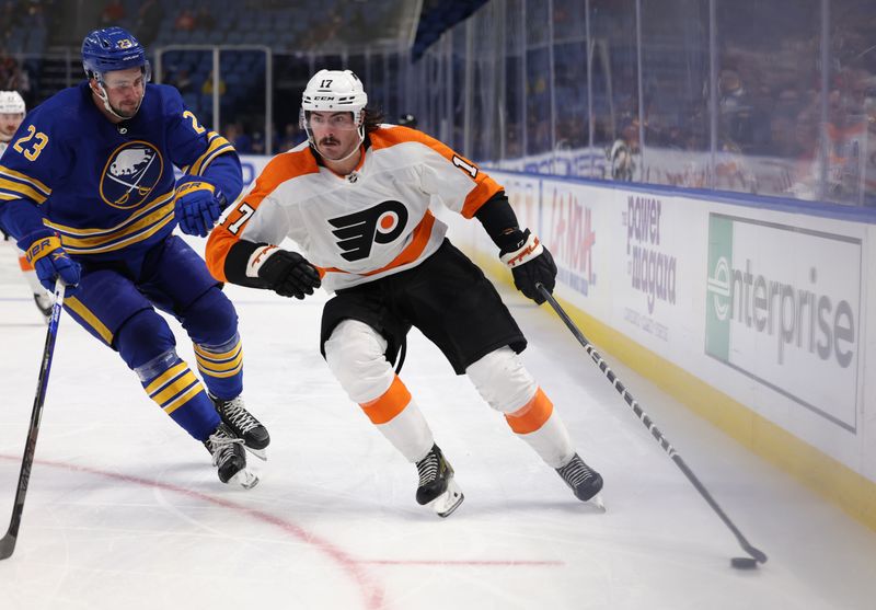 Sep 27, 2022; Buffalo, New York, USA;  Philadelphia Flyers center Zack MacEwen (17) skates with the puck as Buffalo Sabres defenseman Mattias Samuelsson (23) defends during the third period at KeyBank Center. Mandatory Credit: Timothy T. Ludwig-USA TODAY Sports