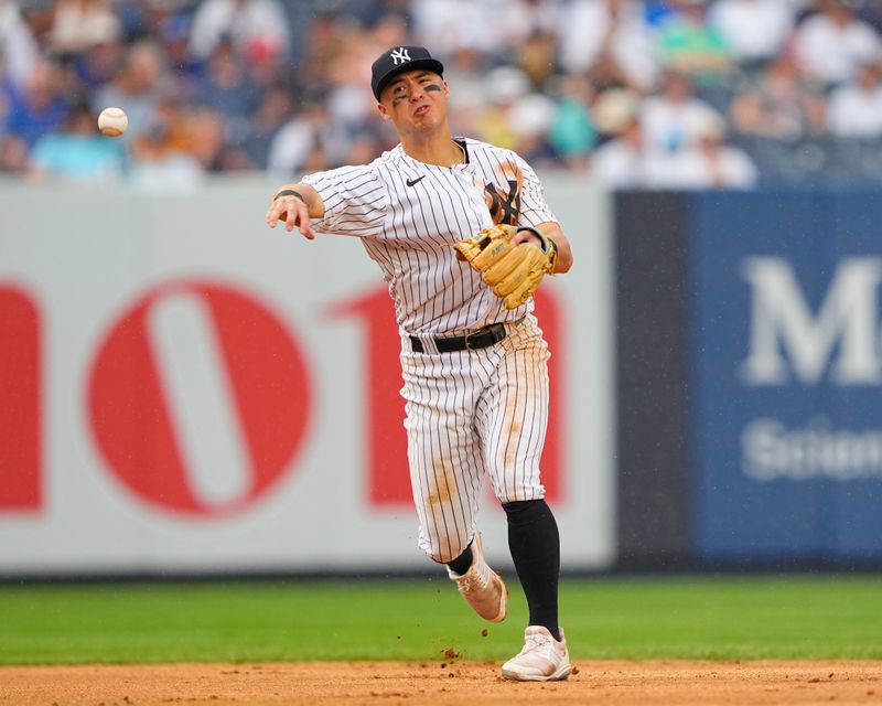 Jul 8, 2023; Bronx, New York, USA; New York Yankees shortstop Anthony Volpe (11) throws out Chicago Cubs first baseman Trey Mancini (not pictured) during the eighth inning at Yankee Stadium. Mandatory Credit: Gregory Fisher-USA TODAY Sports