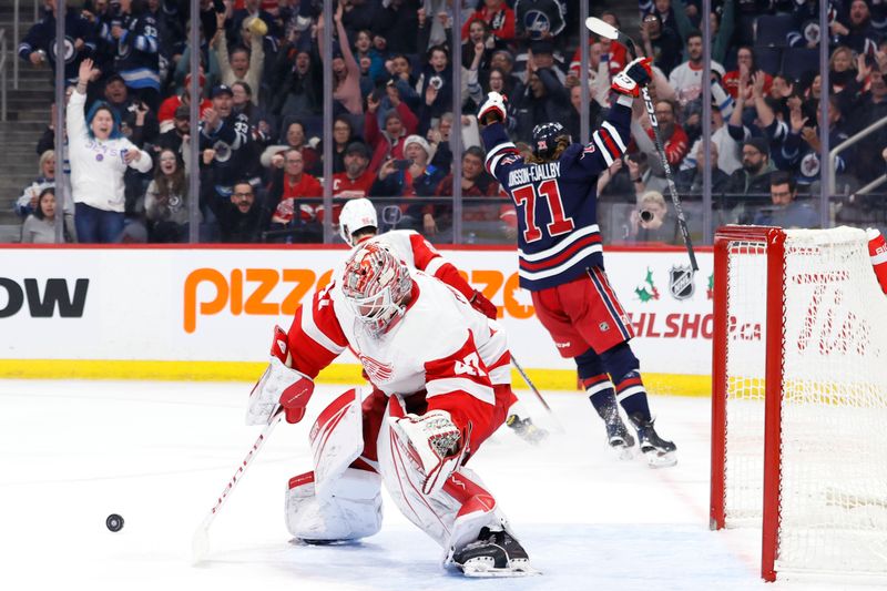 Dec 20, 2023; Winnipeg, Manitoba, CAN; Winnipeg Jets left wing Axel Jonsson-Fjallby (71) celebrates his second period goal on Detroit Red Wings goaltender James Reimer (47) at Canada Life Centre. Mandatory Credit: James Carey Lauder-USA TODAY Sports