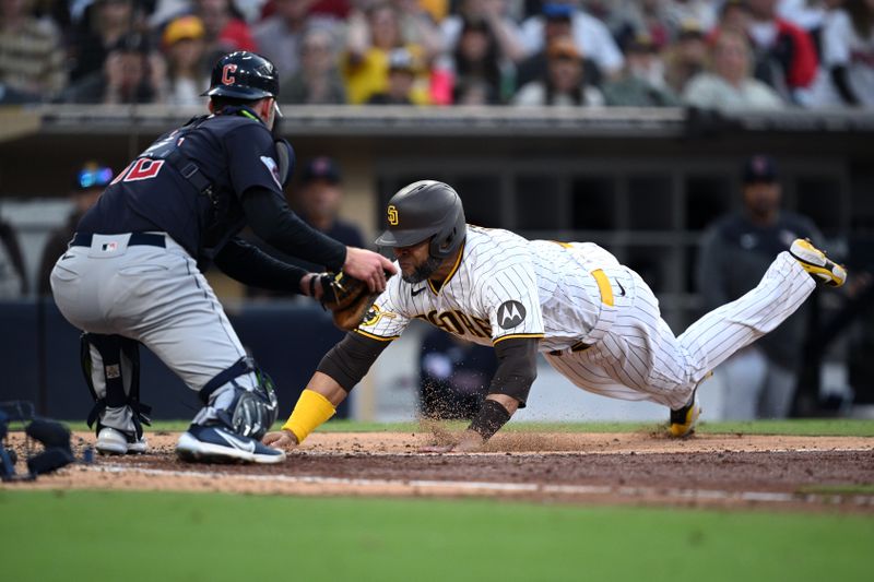 Jun 15, 2023; San Diego, California, USA; San Diego Padres designated hitter Nelson Cruz (right) is tagged out at home by Cleveland Guardians catcher David Fry (12) during the fifth inning at Petco Park. Mandatory Credit: Orlando Ramirez-USA TODAY Sports