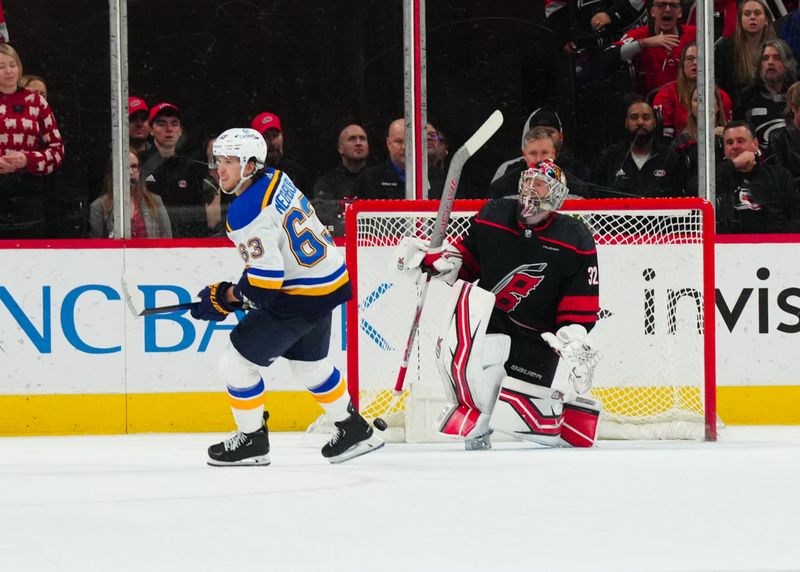 Jan 6, 2024; Raleigh, North Carolina, USA; St. Louis Blues left wing Jake Neighbours (63) scores a goal past Carolina Hurricanes goaltender Antti Raanta (32) in the shoot out at PNC Arena. Mandatory Credit: James Guillory-USA TODAY Sports