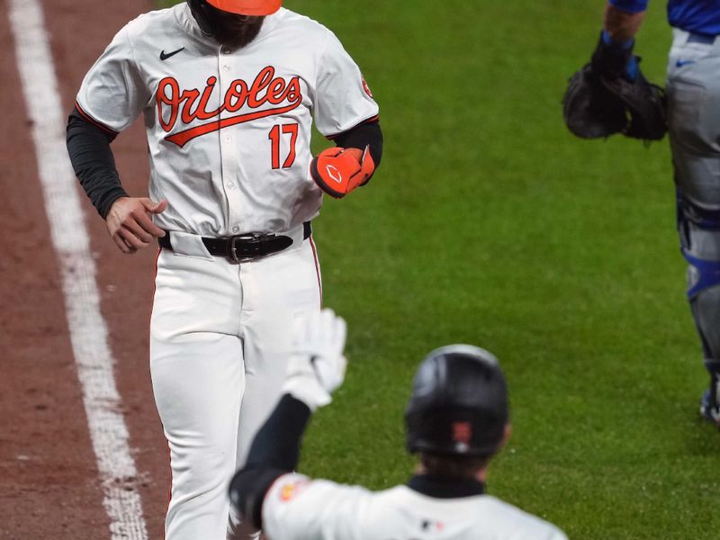 Apr 3, 2024; Baltimore, Maryland, USA; Baltimore Orioles outfielder Colton Cowser (17) is greeted after scoring by designated hitter Adley Rutschman (35) during the eighth inning against the Kansas City Royals at Oriole Park at Camden Yards. Mandatory Credit: Mitch Stringer-USA TODAY Sports