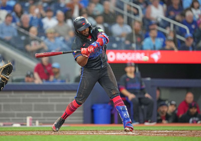 Jun 3, 2024; Toronto, Ontario, CAN; Toronto Blue Jays first baseman Vladimir Guerrero Jr. (27) hits a single against the Baltimore Orioles during the sixth inning at Rogers Centre. Mandatory Credit: Nick Turchiaro-USA TODAY Sports