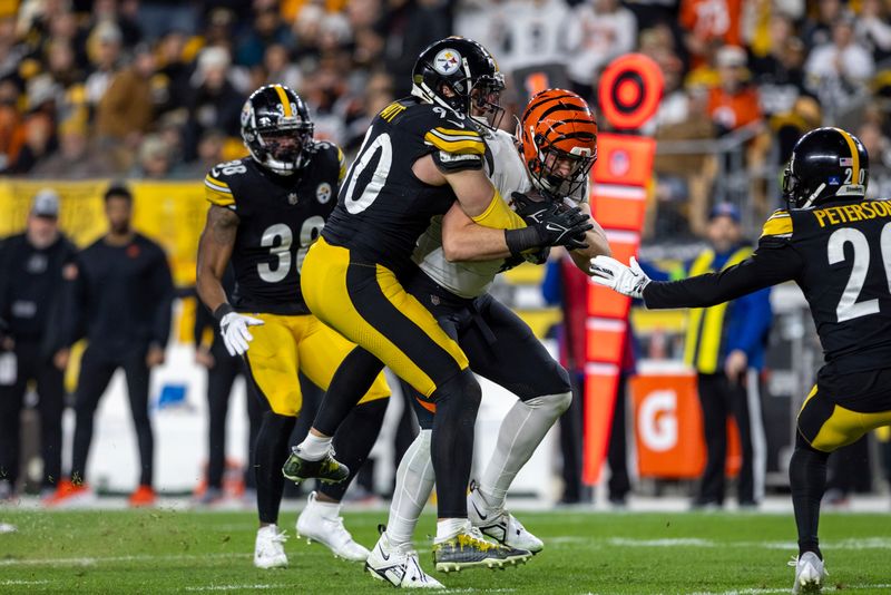 Cincinnati Bengals tight end Drew Sample (89) is tackled by Pittsburgh Steelers linebacker T.J. Watt (90) during an NFL football game, Saturday, Dec. 23, 2023, in Pittsburgh. (AP Photo/Matt Durisko)