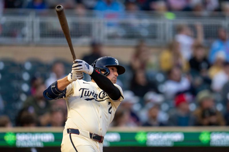 Apr 22, 2025; Minneapolis, Minnesota, USA; Minnesota Twins third baseman Brooks Lee (2) hits a single against the Chicago White Sox in the fourth inning at Target Field. Mandatory Credit: Jesse Johnson-Imagn Images