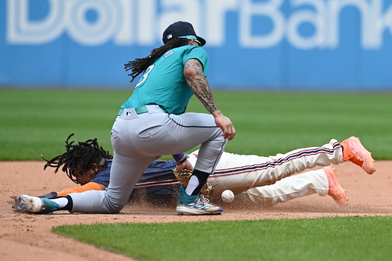 Jun 20, 2024; Cleveland, Ohio, USA; Cleveland Guardians designated hitter Jose Ramirez (11) steals second as Seattle Mariners shortstop J.P. Crawford (3) loses the ball during the fifth inning at Progressive Field. Mandatory Credit: Ken Blaze-USA TODAY Sports