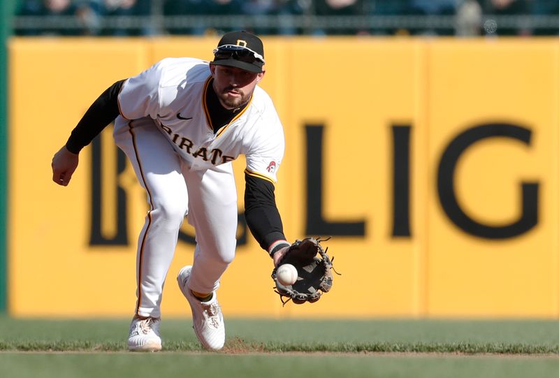 Apr 20, 2024; Pittsburgh, Pennsylvania, USA;  Pittsburgh Pirates second baseman Jared Triolo (19) fields a ground ball for an out during the fourth inning at PNC Park. Mandatory Credit: Charles LeClaire-USA TODAY Sports