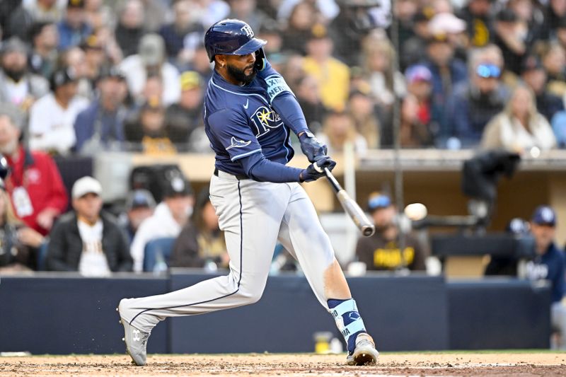Apr 26, 2025; San Diego, California, USA; Tampa Bay Rays third baseman Junior Caminero (13) hits a double during the fifth inning against the San Diego Padres at Petco Park. Mandatory Credit: Denis Poroy-Imagn Images