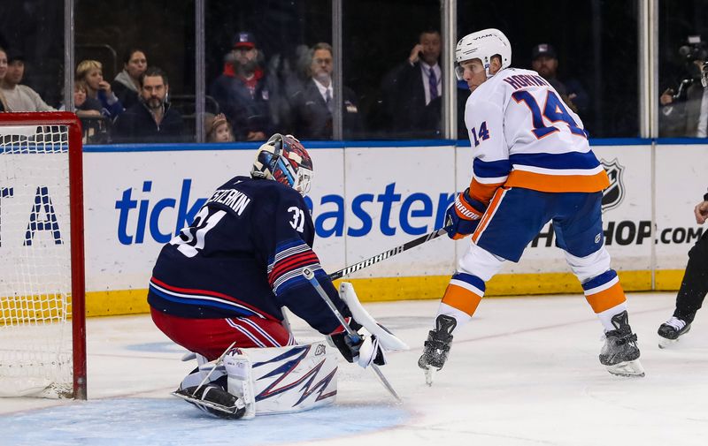 Nov 3, 2024; New York, New York, USA; New York Rangers goalie Igor Shesterkin (31) makes a save on New York Islanders center Bo Horvat (14) during the second period at Madison Square Garden. Mandatory Credit: Danny Wild-Imagn Images